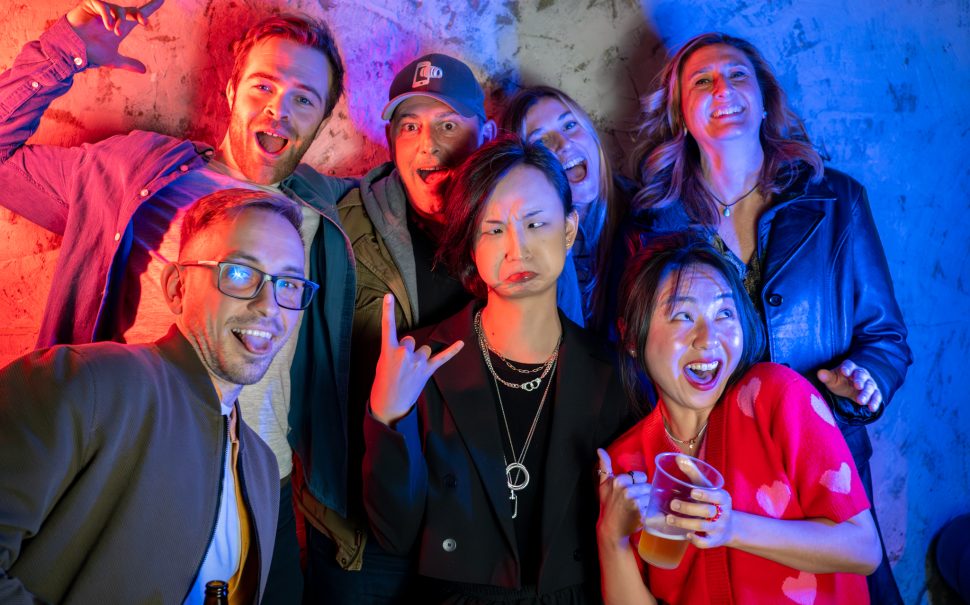 Seven people pull silly faces for the camera.