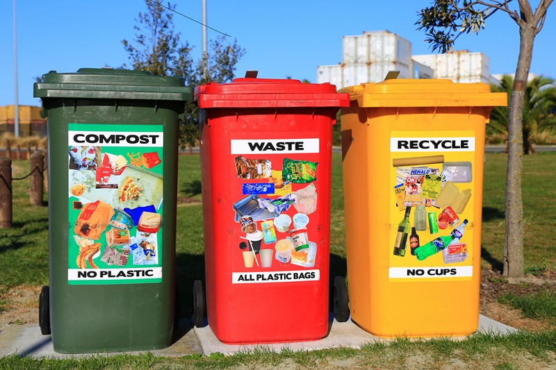 image of three bins, green red and yellow, which are labelled "compost" "waste" and "recycle"