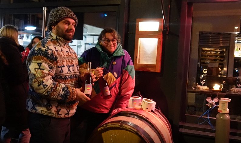 Wine makers holding bottles of Boujolais Nouveau