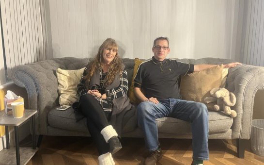 Siobhain and David pictured sat on a sofa