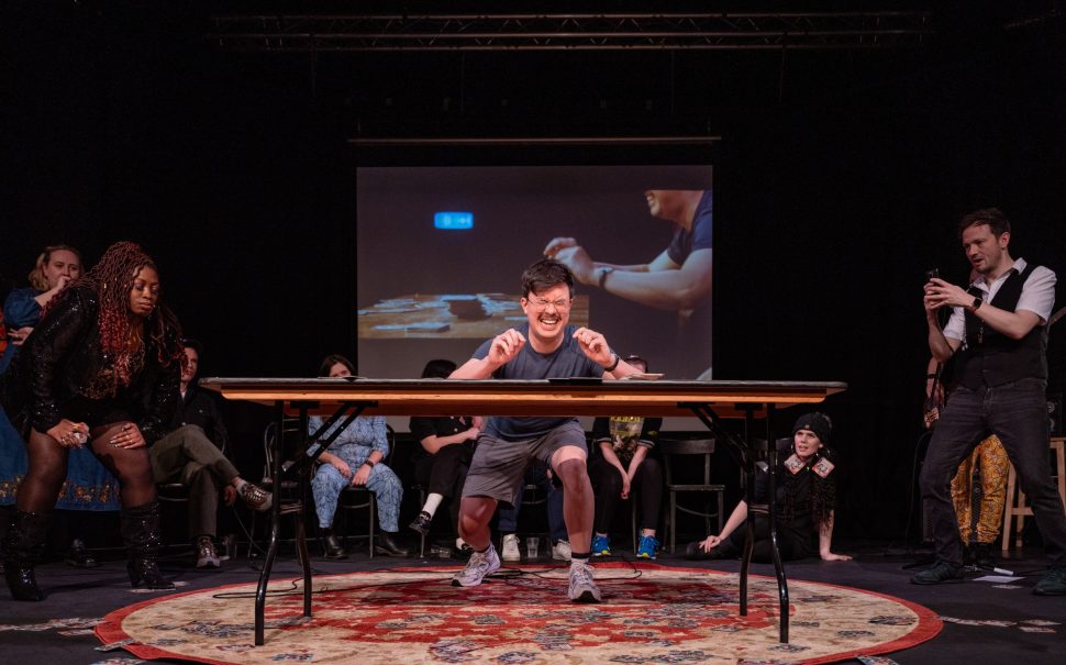 Comedian Phil Wang takes part in the Comedians Beer Mat Flipping Championships