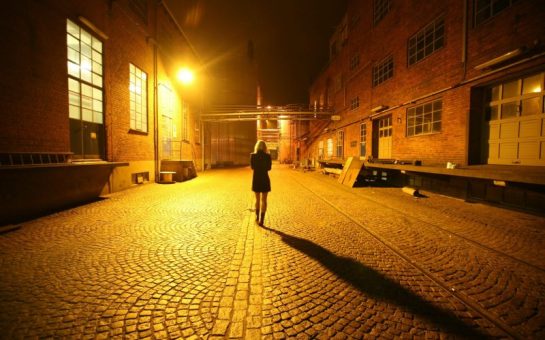 A woman stood alone in a dark street