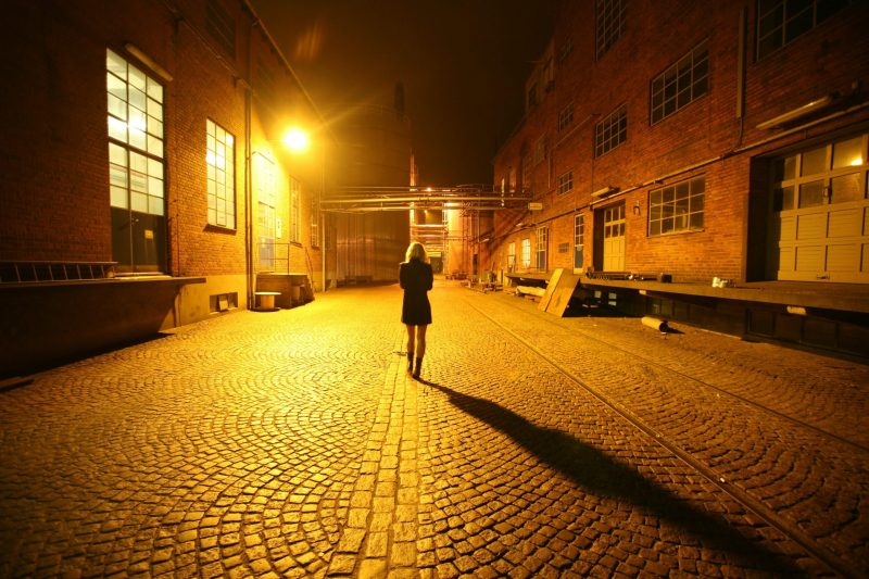 A woman stood alone in a dark street